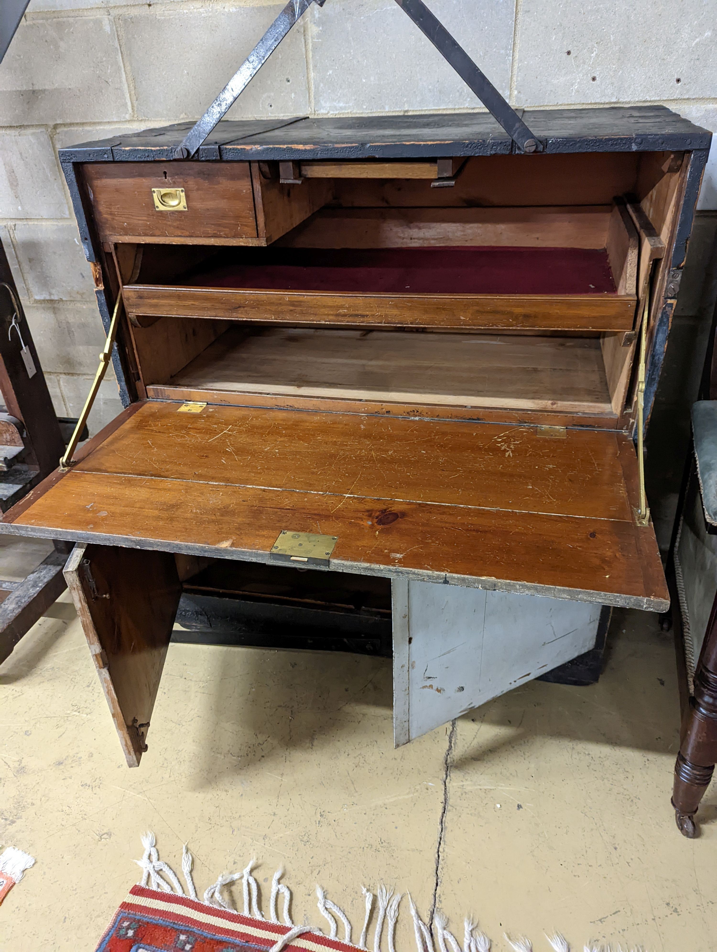 An early 20th century painted and stained pine campaign chest - owners name plate for W.E Higham, R.N. , retailers name plate Gieve’s. W-106cm, D-54cm, H-114cm.